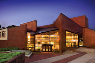 Williams Center for the Arts facade, lit from within at dusk